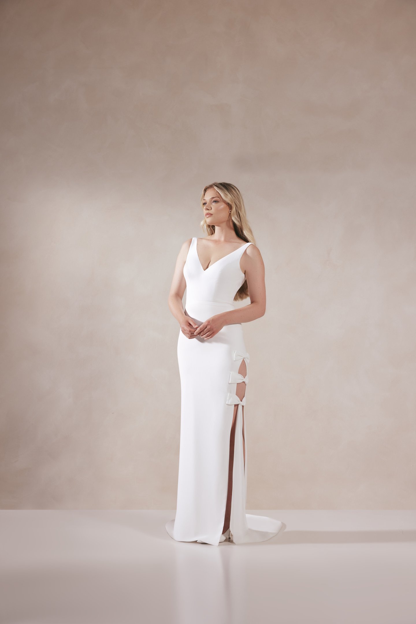 Adore by Justin Alexander Style 11380 Nellie Stretch Crepe Fit and Flare Gown with Skirt Slit and Bow Details