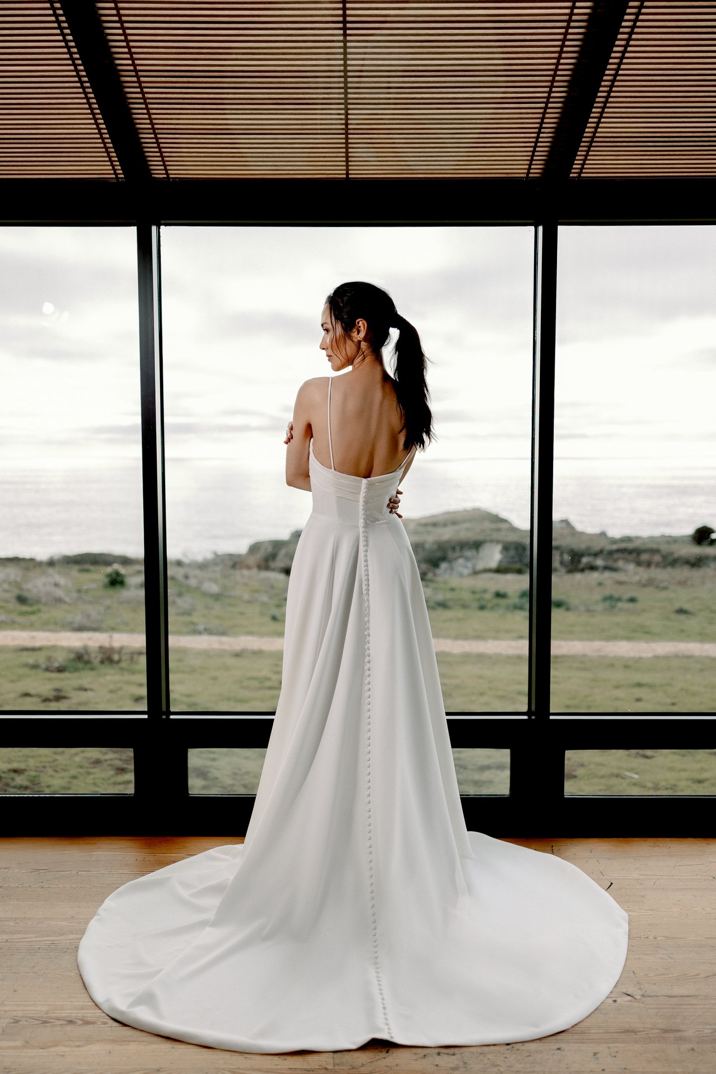 Adore by Justin Alexander Style 11413 Sereia Clean Crepe A-Line Gown with Twisted Bikini Neckline and Pockets Cut-Out Detail