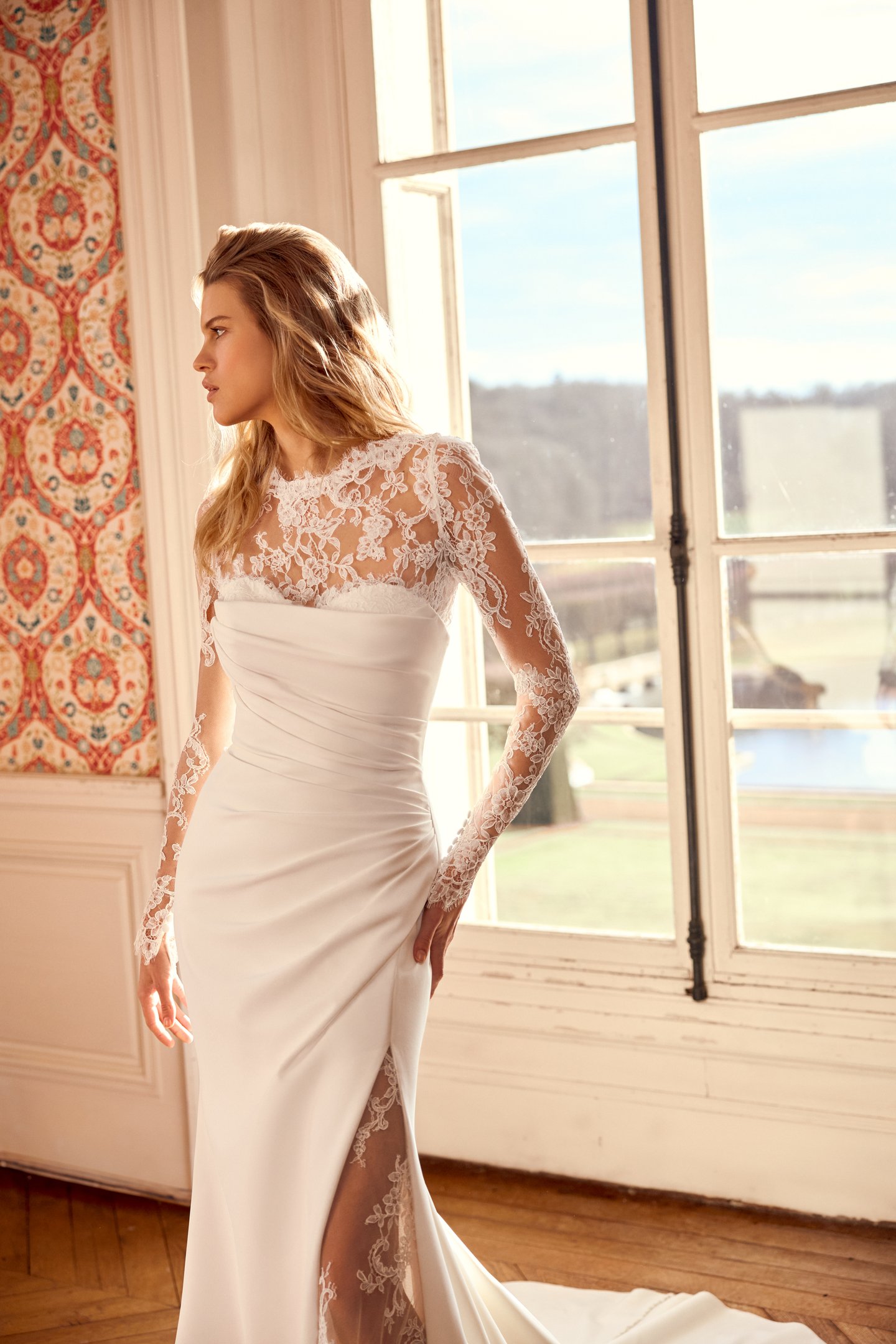 Justin Alexander Style 88544 Noryn Strapless Crepe Fit and Flare Bridal Gown with Asymmetrical Draped Crepe on Bodice with Sultry Skirt Slit