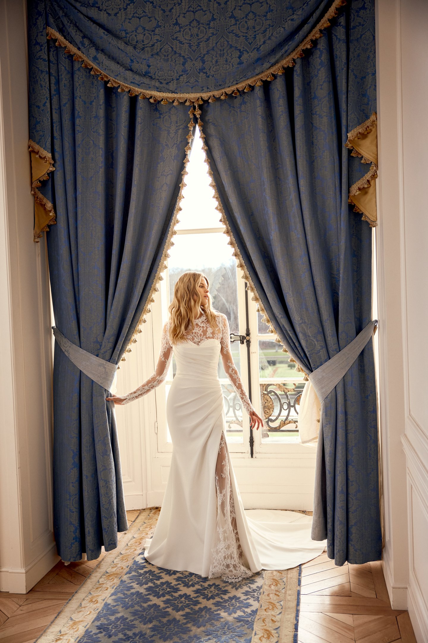 Justin Alexander Style 88544 Noryn Strapless Crepe Fit and Flare Bridal Gown with Asymmetrical Draped Crepe on Bodice with Sultry Skirt Slit