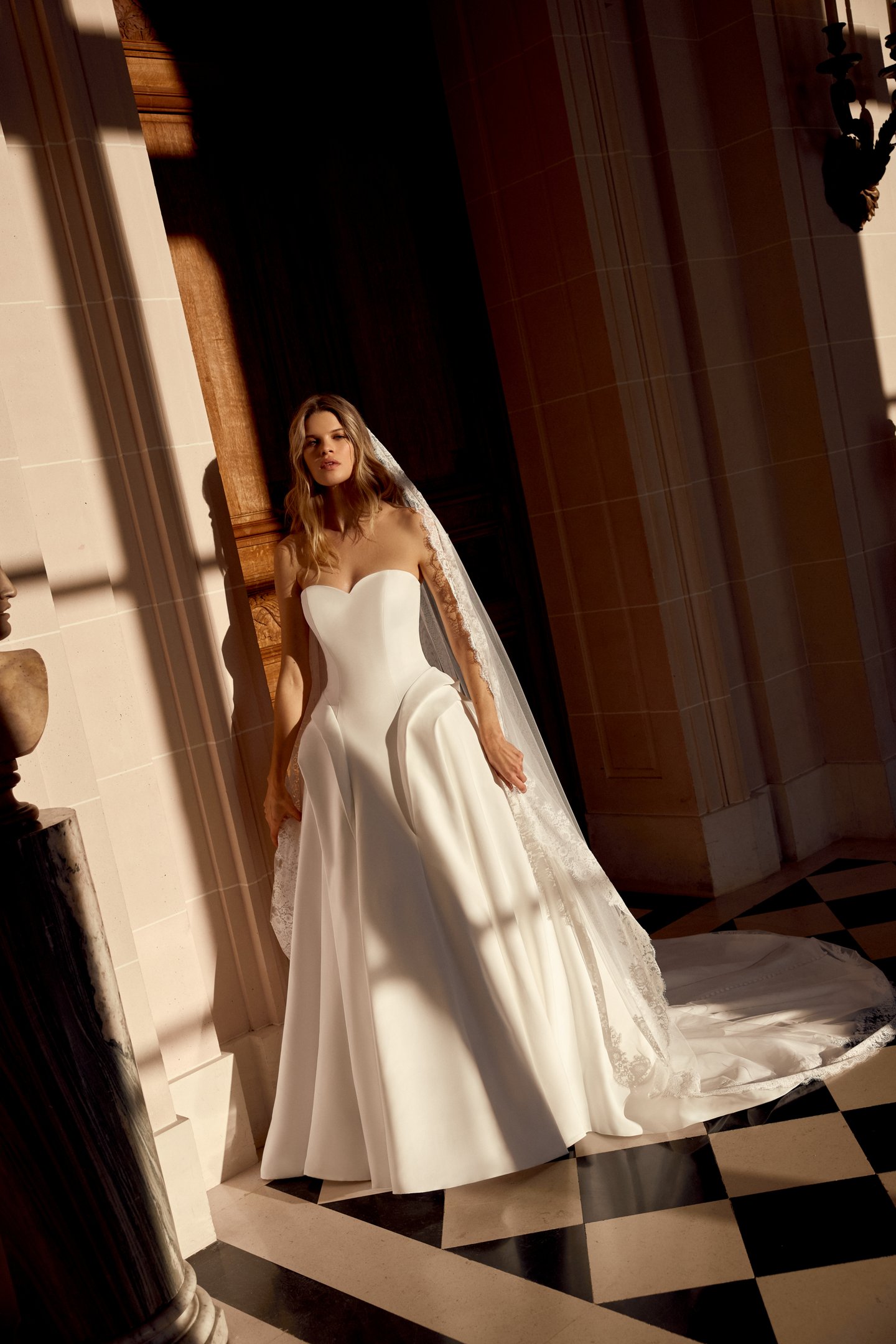 Justin Alexander Style 88546 Noble Satin A-Line Gown with Sculptural Waterfall Waistline and Tiered Peplum Details