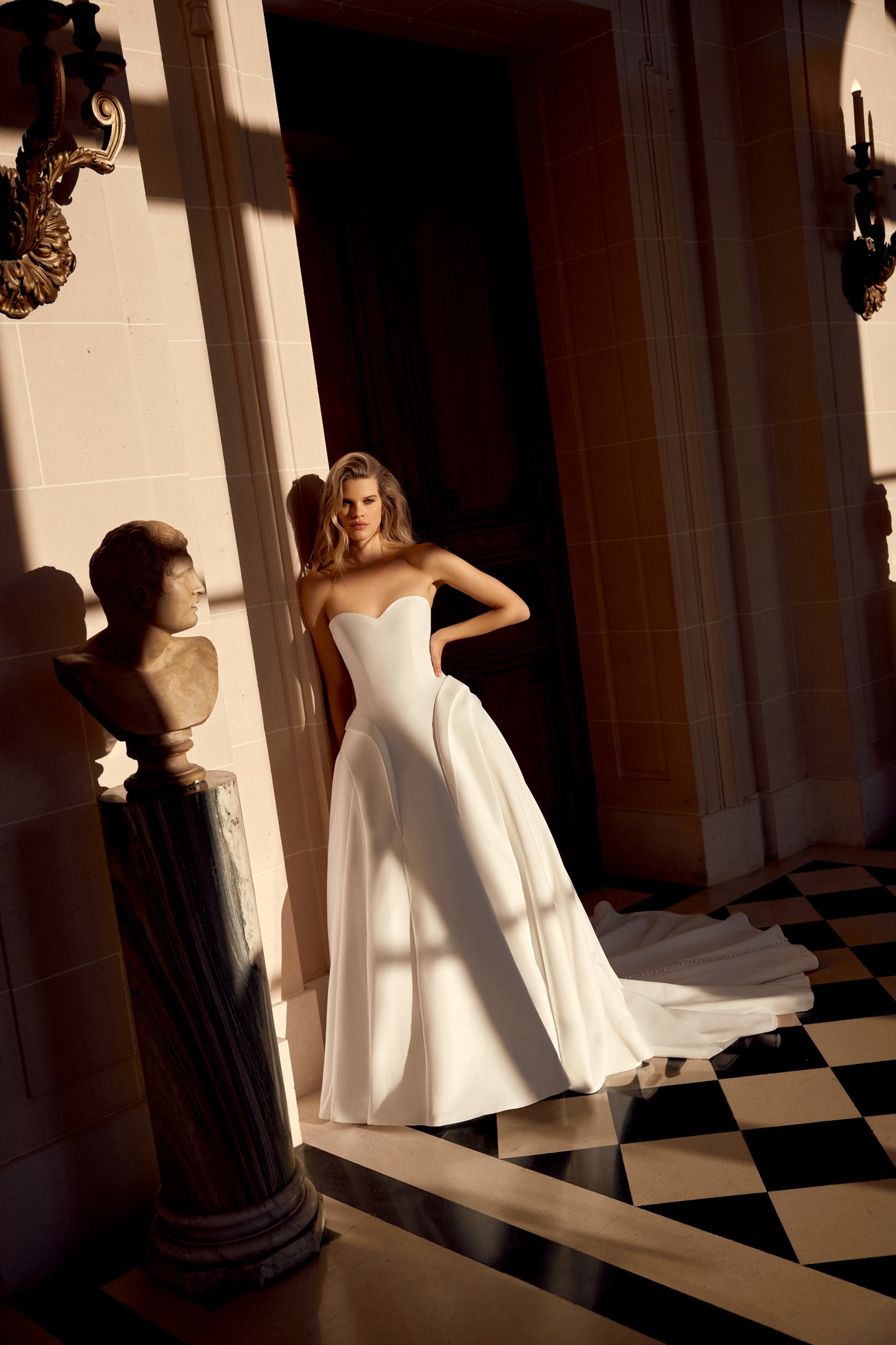 Justin Alexander Style 88546 Noble Satin A-Line Gown with Sculptural Waterfall Waistline and Tiered Peplum Details