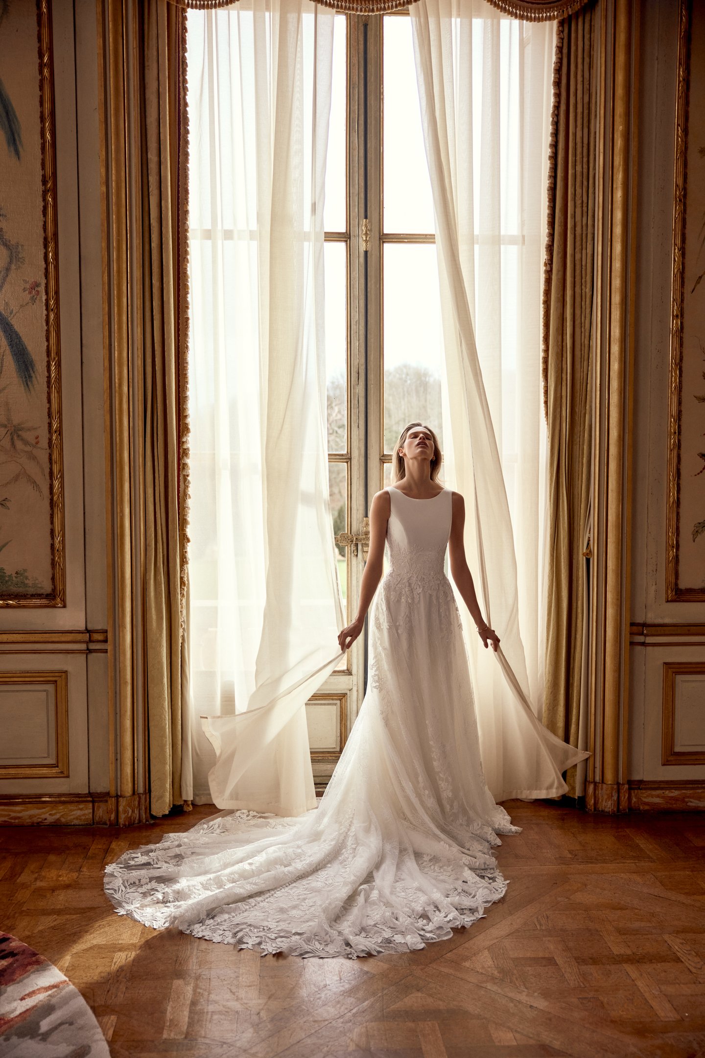 Justin Alexander Style 88549 Neve A-Line Gown with Sabrina Neckline, Crepe Bodice with Floral Lace Appliqués, and Chantilly Lace Skirt