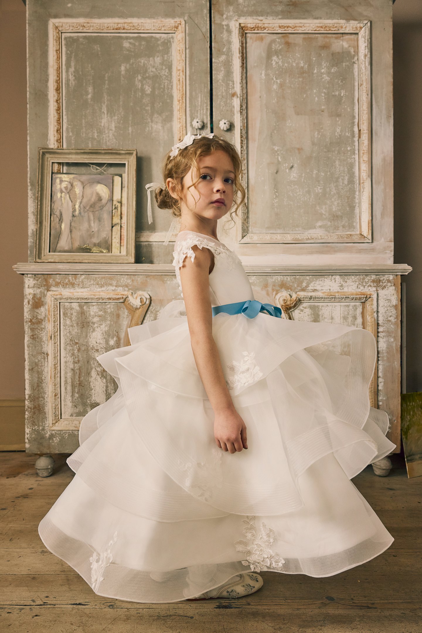 Fable by Justin Alexander Style FG015 Norah Organza Tea Length Ball Gown with Illusion Neckline, Floral Lace Appliqués, and Ruffled Layered Skirt