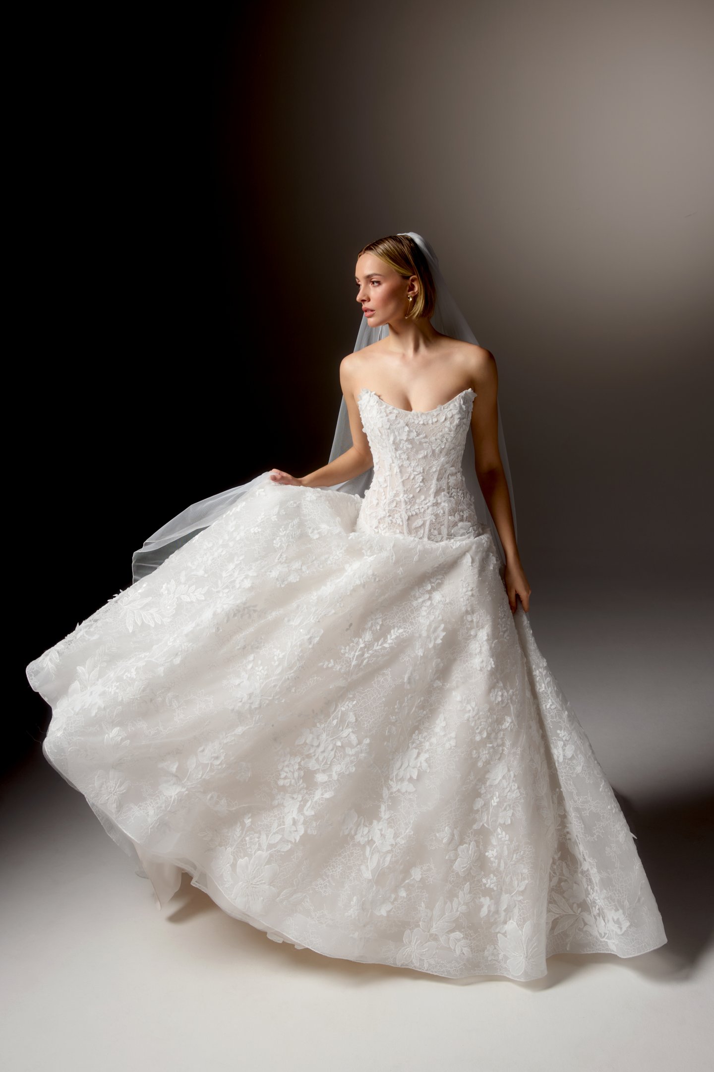 Justin Alexander Signature Style 99407 CARAVINA Allover Lace Dropped Waistline Ball Gown with Strapless Cat Eye Neckline and Matte Floral Appliqués and 3D Chiffon Florals