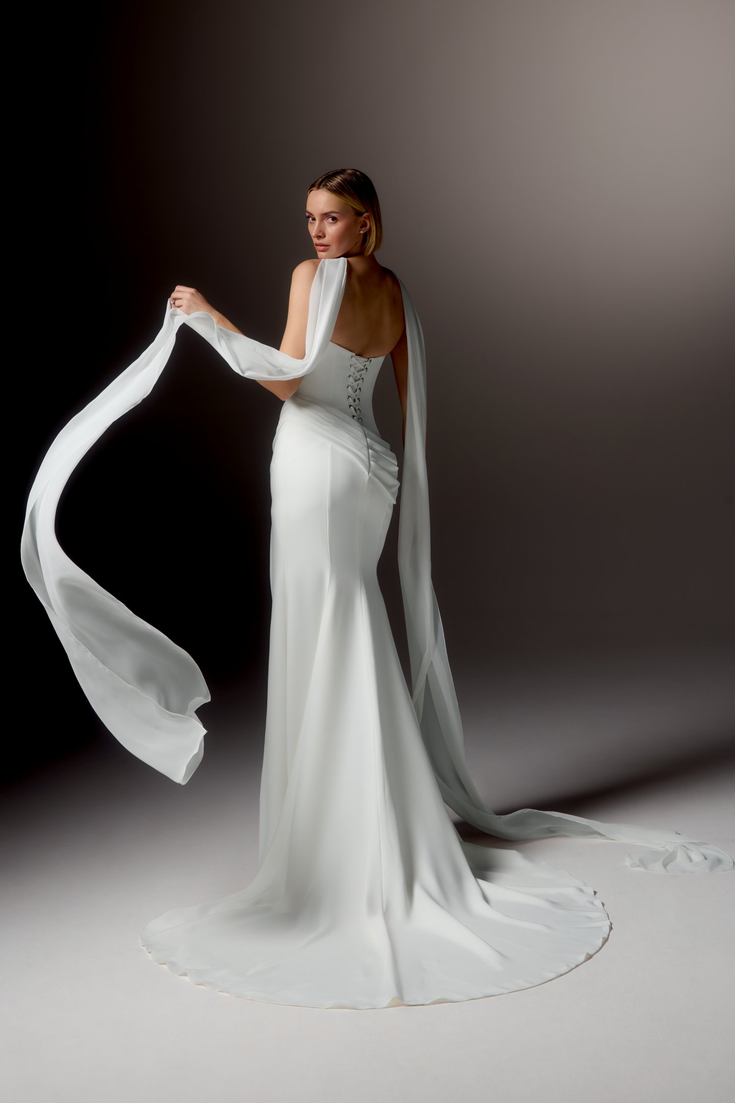 Justin Alexander Signature Style 99413 LUCIDA Clean Silky Crepe Fit and Flare Gown with Strapless Arched Neckline and Asymmetrical Waistline