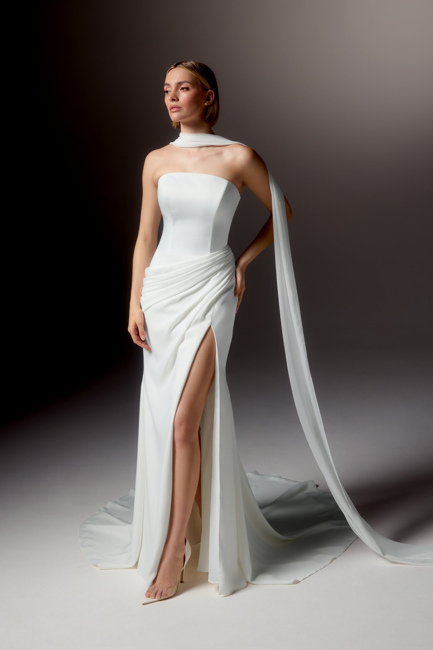 Justin Alexander Signature Style 99413 LUCIDA Clean Silky Crepe Fit and Flare Gown with Strapless Arched Neckline and Asymmetrical Waistline