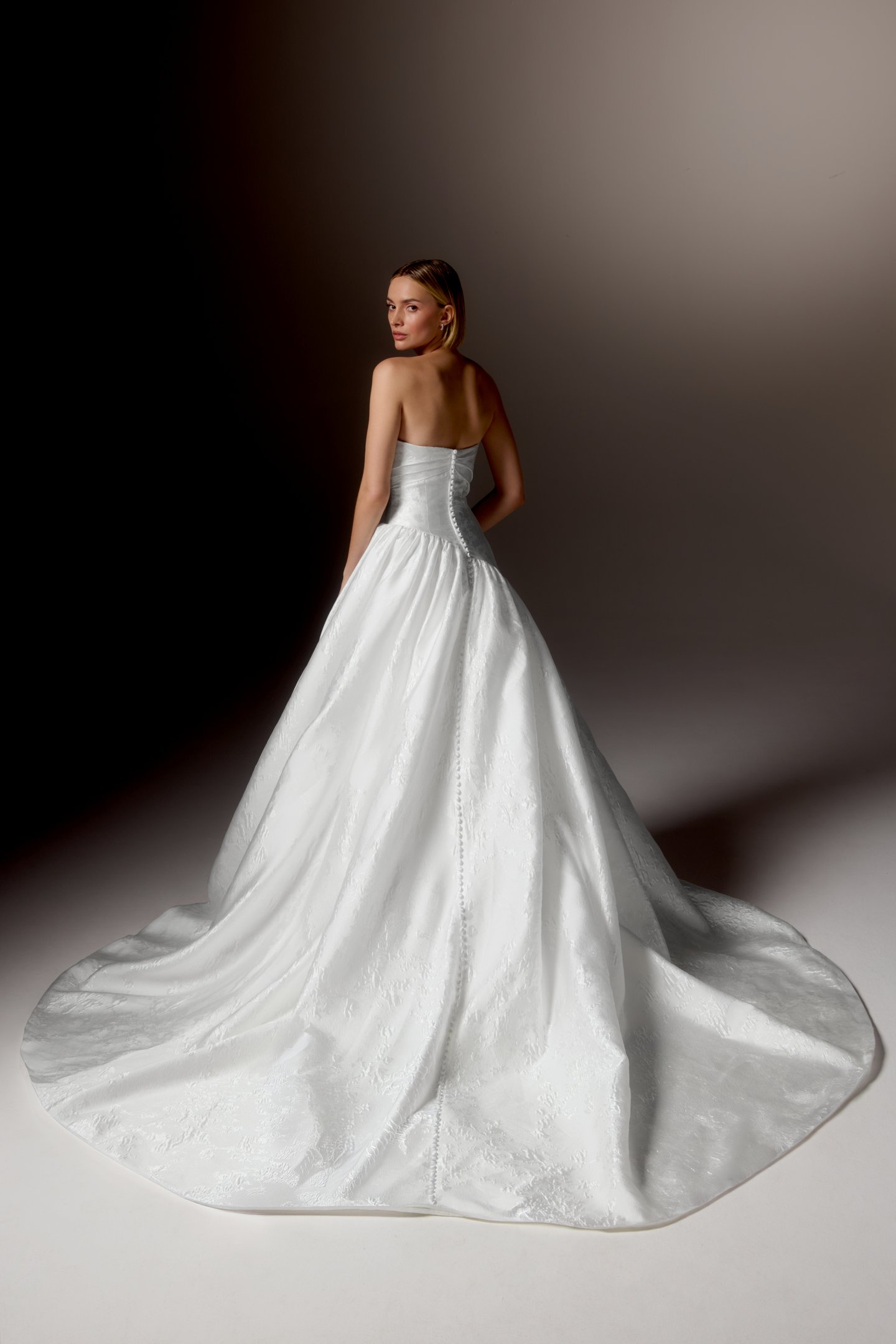 Justin Alexander Signature Style 99418 CARAVELLA Brocade Ball Gown with Strapless Cuff Neckline, Asymmetrical Waistline, and Dramatic Gathered Skirt