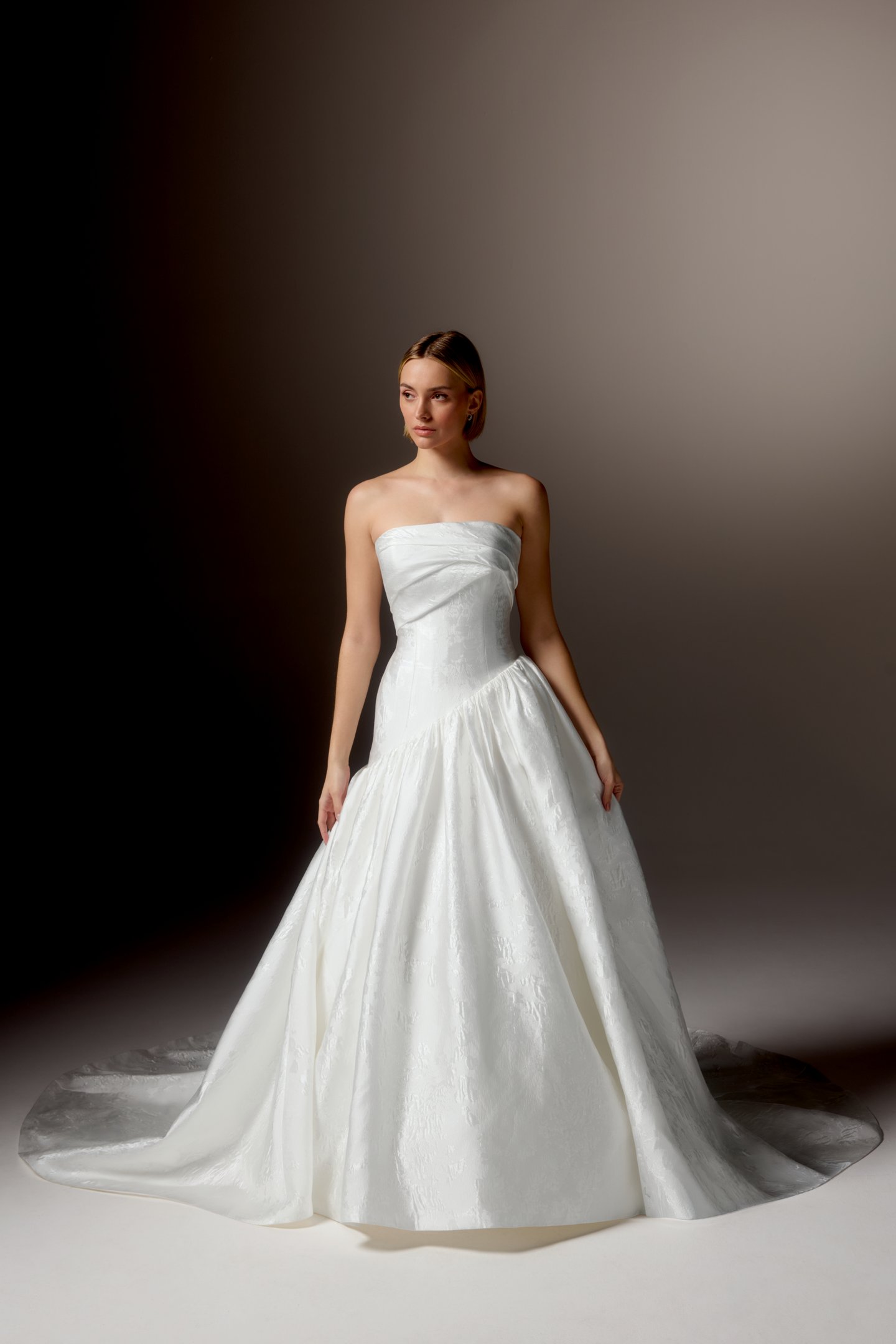 Justin Alexander Signature Style 99418 CARAVELLA Brocade Ball Gown with Strapless Cuff Neckline, Asymmetrical Waistline, and Dramatic Gathered Skirt