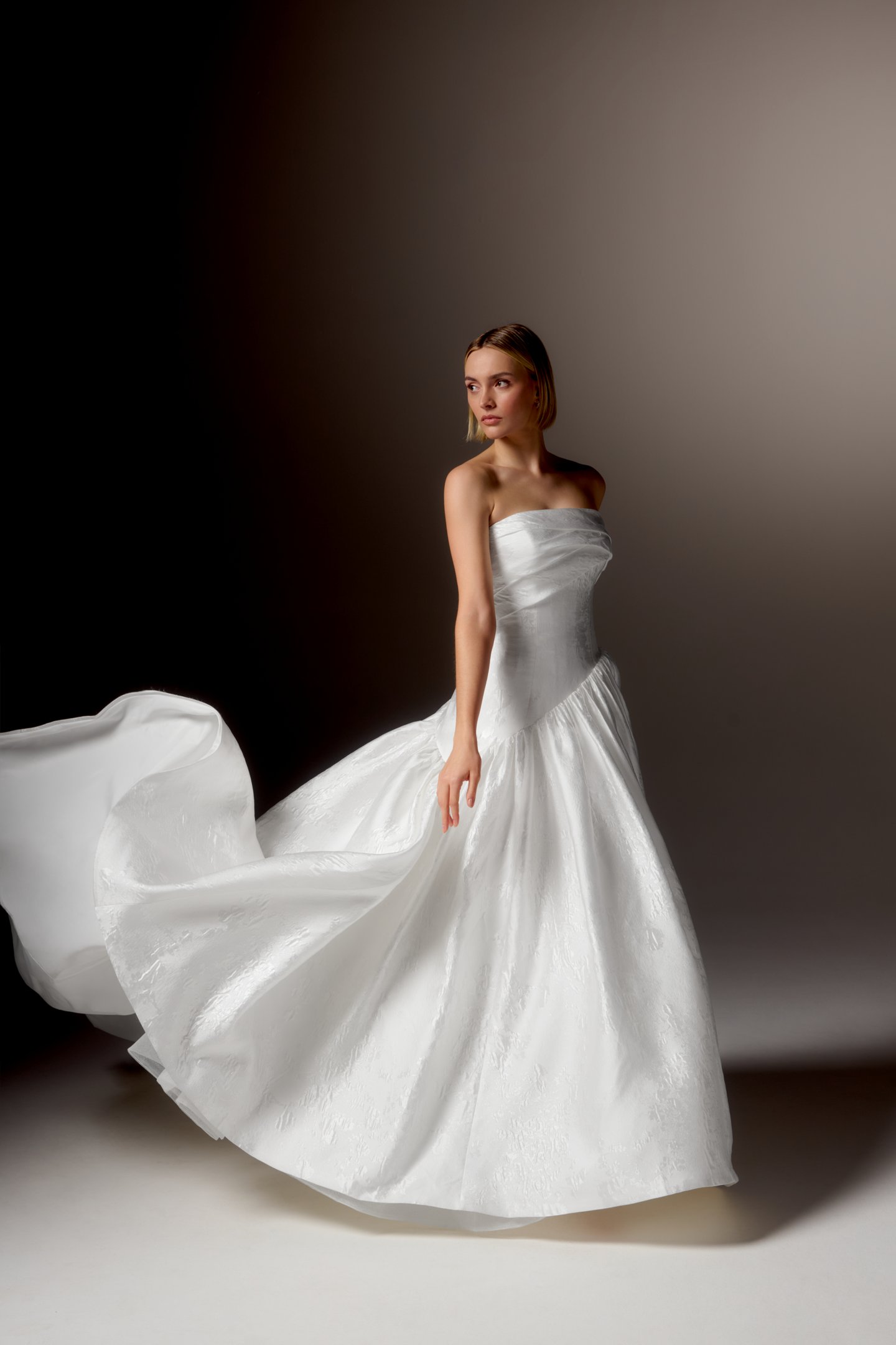 Justin Alexander Signature Style 99418 CARAVELLA Brocade Ball Gown with Strapless Cuff Neckline, Asymmetrical Waistline, and Dramatic Gathered Skirt