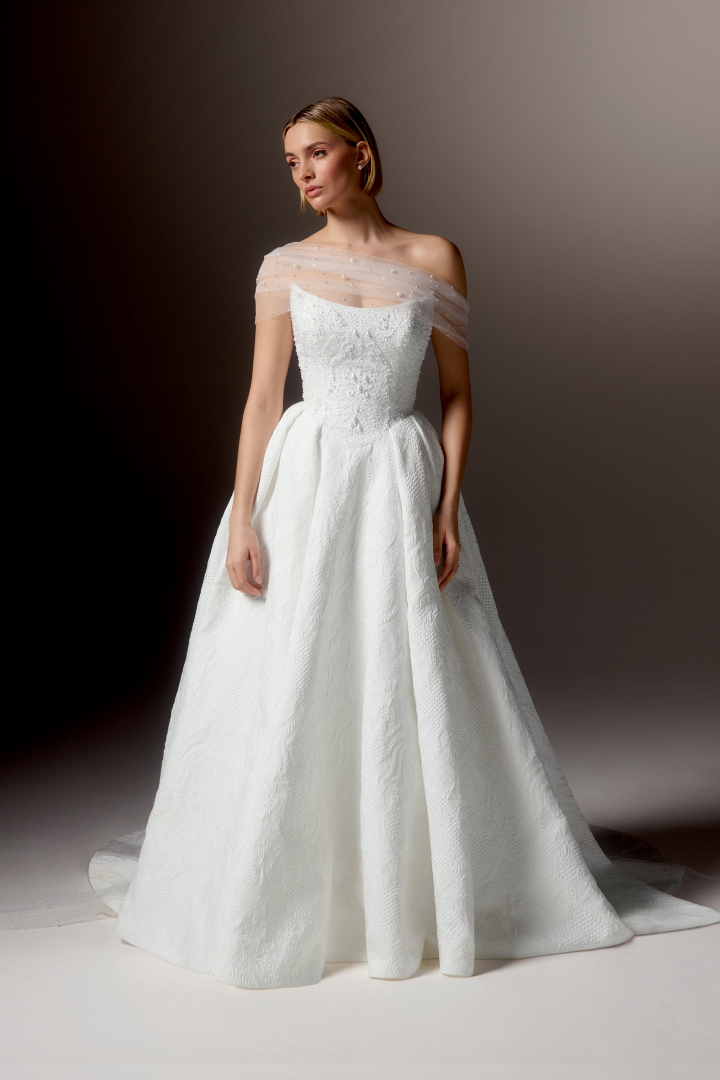 Justin Alexander Signature Style 99424 OMBRETTA Textured Brocade Ball Gown with Cat Eye Neckline, Beaded Bodice, and Basque Waistline
