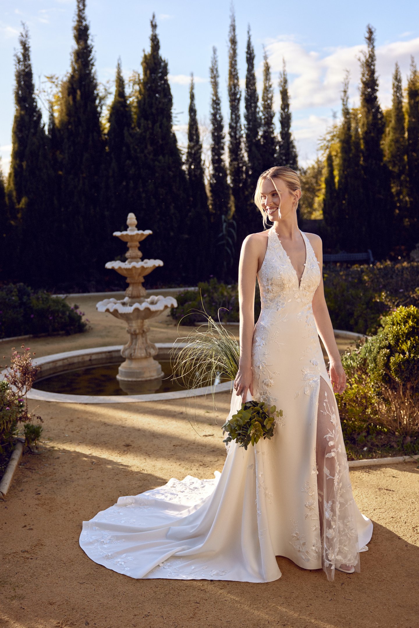 Lillian West Style 66436 Crepe Fit and Flare Gown with Halter Neckline and Green Appliqués