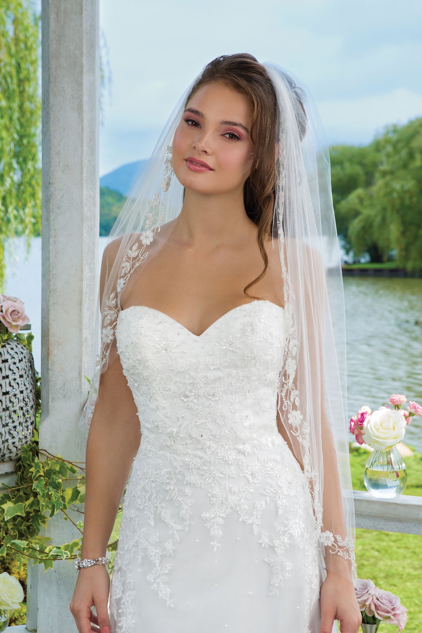 Sweetheart Gowns Style 6096 Beaded emboridered lace and tulle Slim A-line accentuated by a sweetheart neckline.