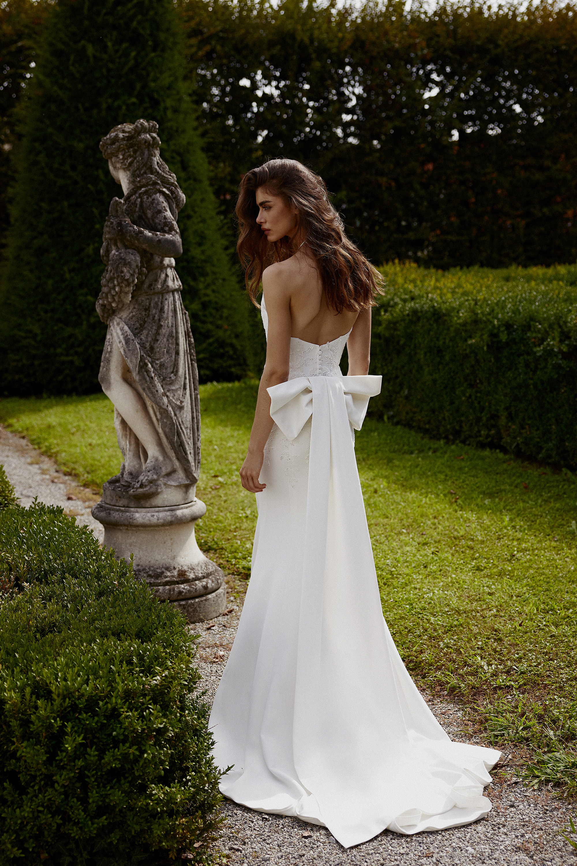 Justin Alexander Style 88383 Isdora Crepe Fit and Flare with Pointed Neckline and Detachable Bow